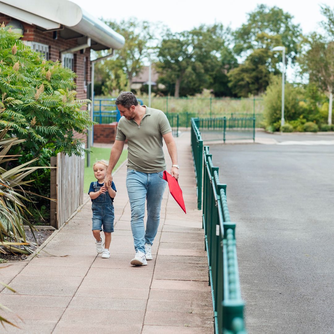 a dad walking his son into daycare