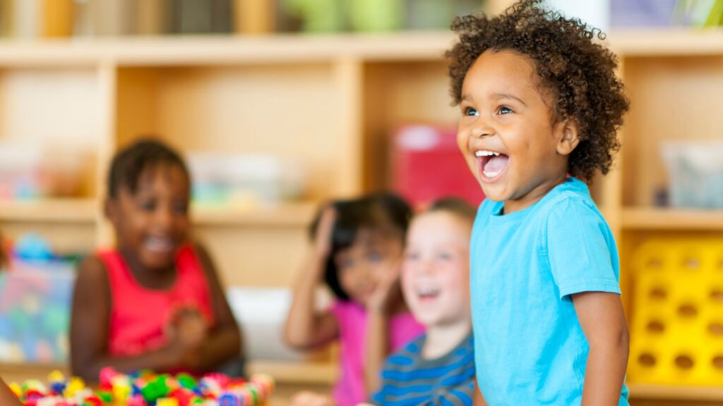 happy preschooler in class